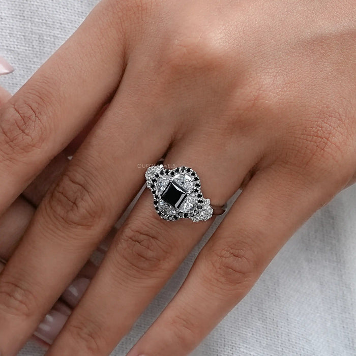 princess cut black diamond half moon halo engagement ring in finger