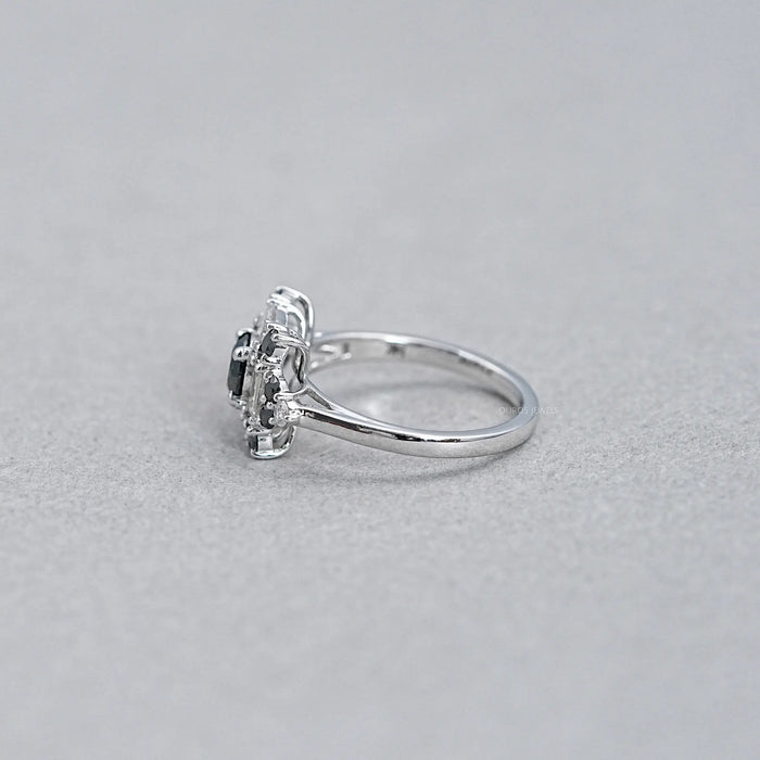 side view of black round lab diamond baguette halo ring on grey fabric