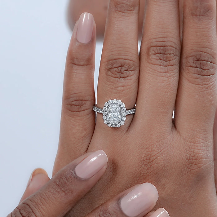 cushion cut lab diamond halo engagement ring on model's hand