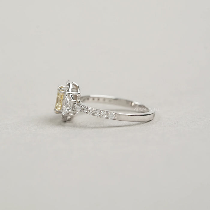 left view of yellow radiant cut diamond three stone halo engagement ring