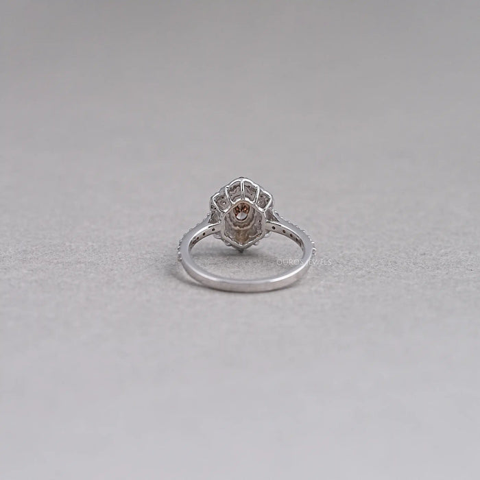 back view of oval cut brown diamond double halo engagement ring on grey fabric