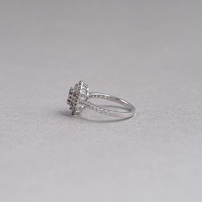 side view of oval cut brown diamond double halo engagement ring on grey fabric