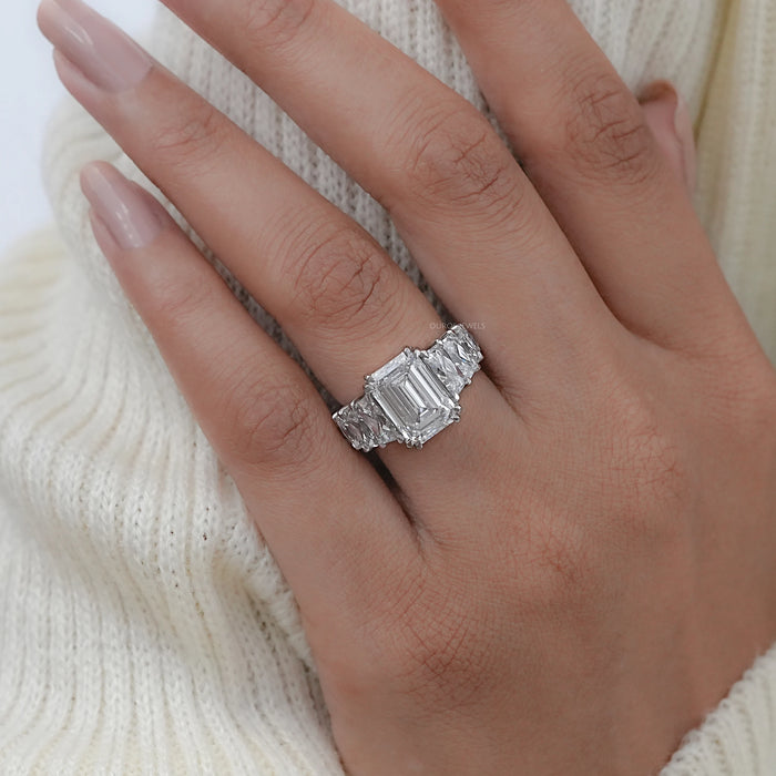 emerald-cut diamond trapezoid solitaire accent engagement ring on model's finger
