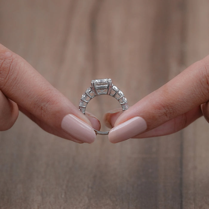 close view of emerald-cut lab diamond trapezoid solitaire accent engagement ring
