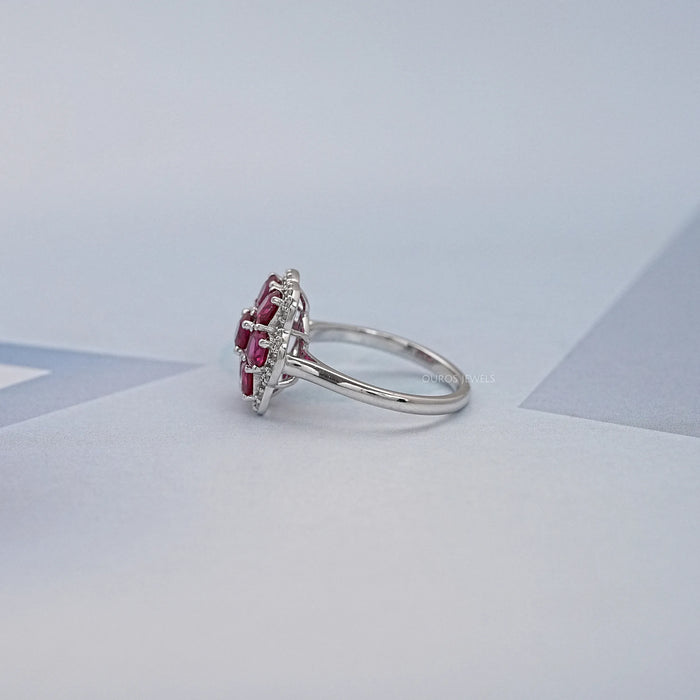 side view of red ruby cushion cut & round diamond floral halo engagement ring