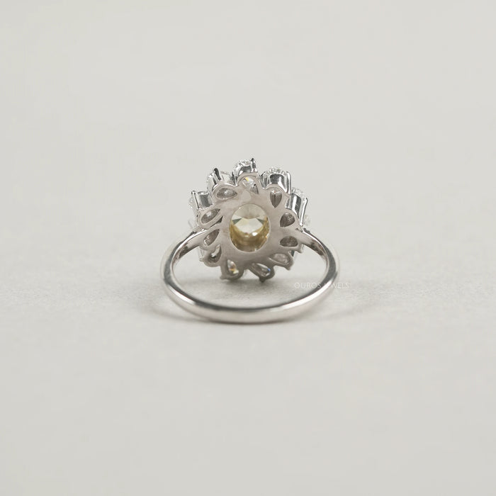 back view of yellow oval cut diamond bezel set with pear halo engagement ring