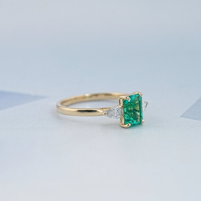 Emerald Gemstone And Pear Diamond Trio Engagement Ring