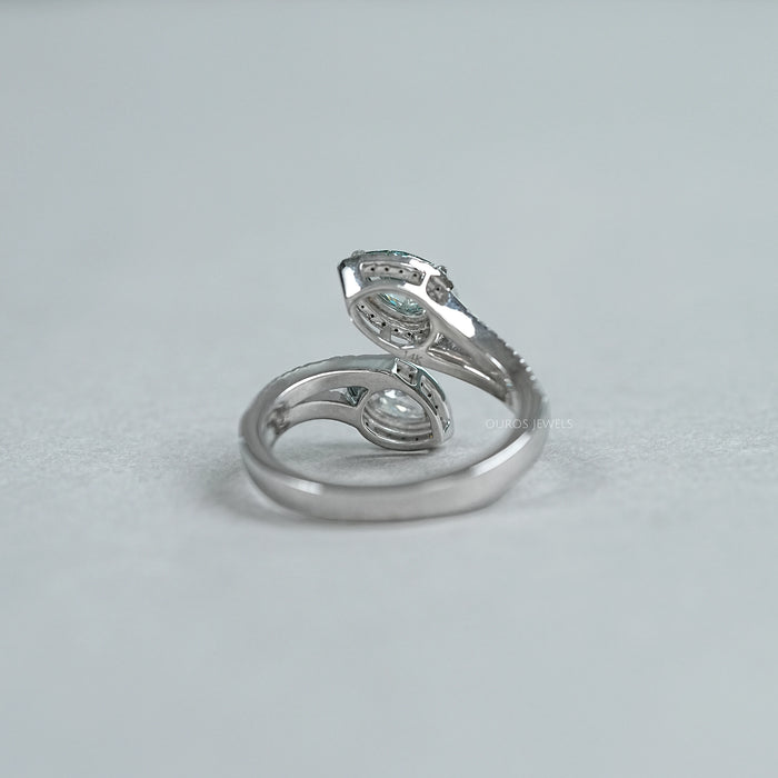 back view of fancy vivid green pear cut diamond bypass halo ring on grey fabric