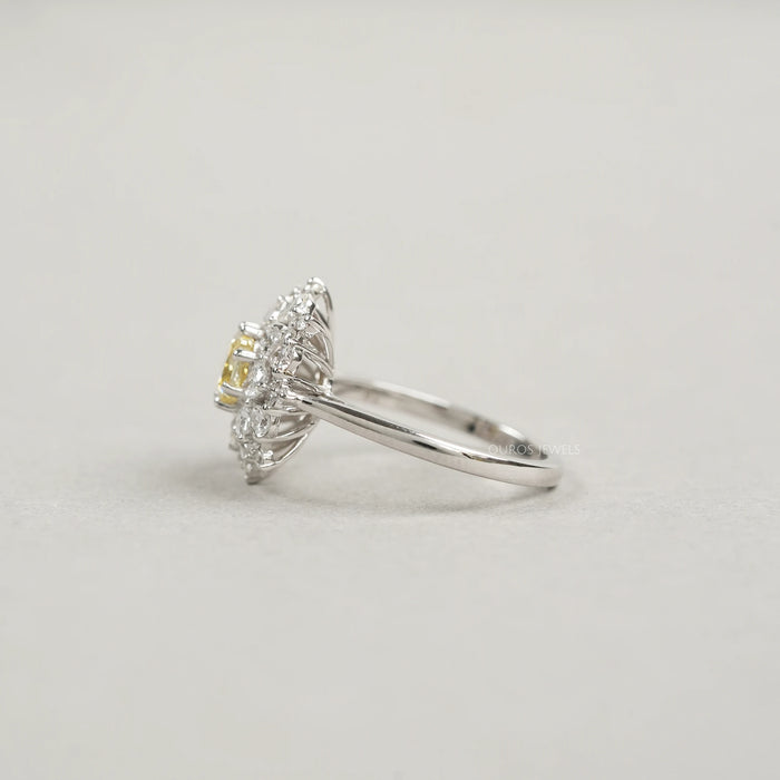 side view of fancy yellow cushion cut diamond with heart & pear sunburst halo ring