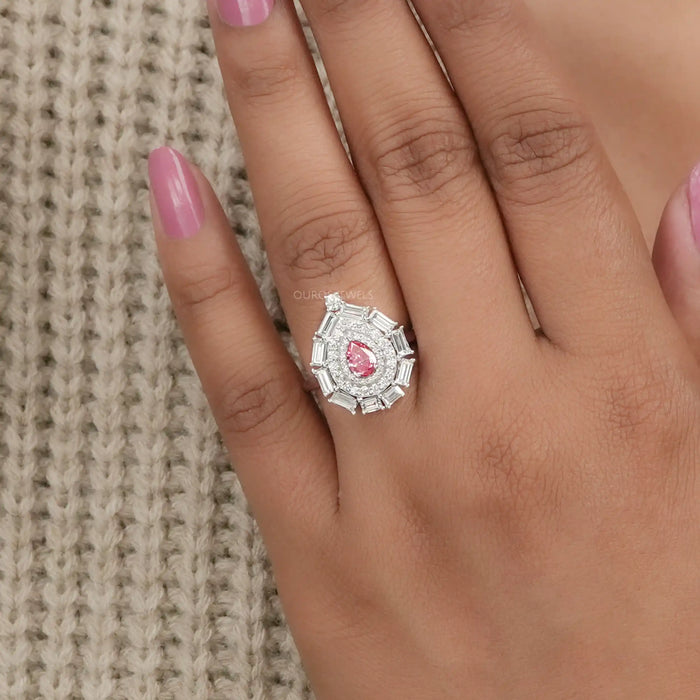 pink pear with baguette and round diamond double halo wedding ring in finger