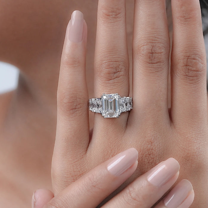 emerald-cut lab diamond trapezoid solitaire accent engagement ring in finger