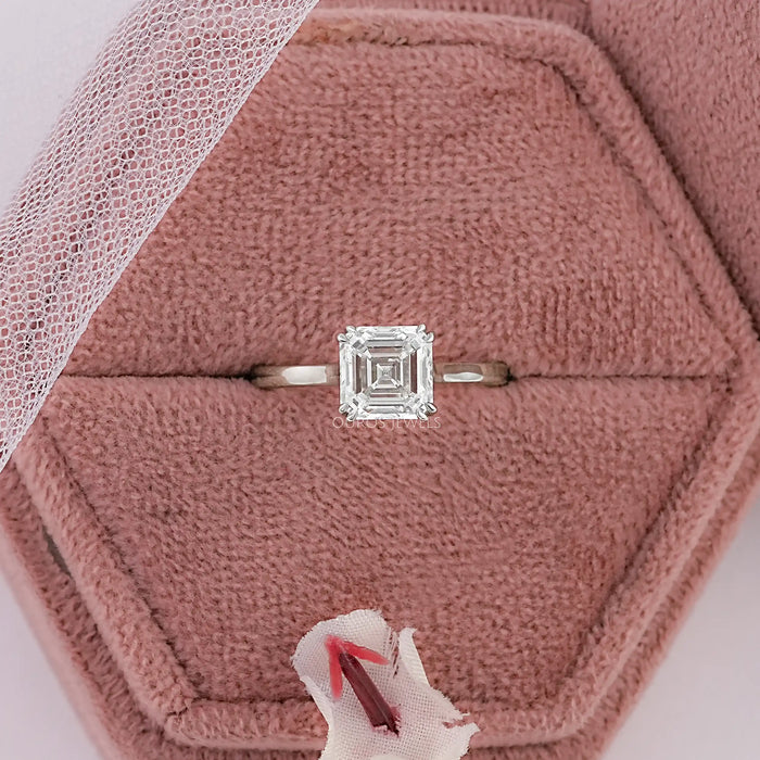 asscher cut diamond double prong engagement ring in jewelry box