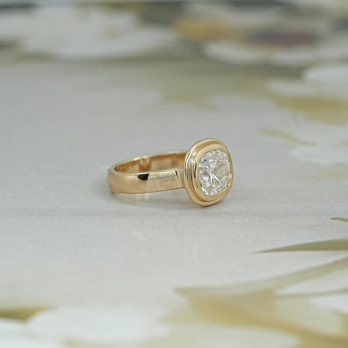 right side view of old mine cushion cut lab diamond bezel set engagement ring