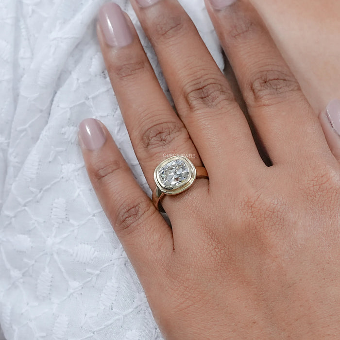 old mine cushion cut lab diamond bezel set engagement ring on model's hand