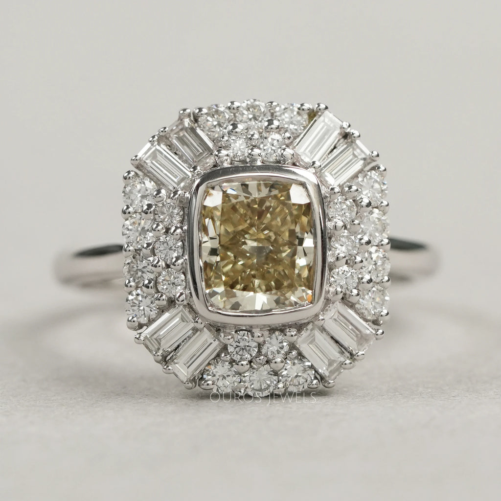 top view of yellow cushion cut diamond bezel set halo cluster engagement ring