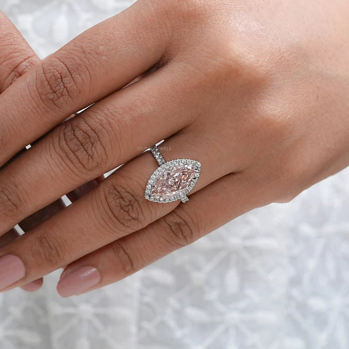 pink marquise cut lab diamond halo engagement ring on model's finger