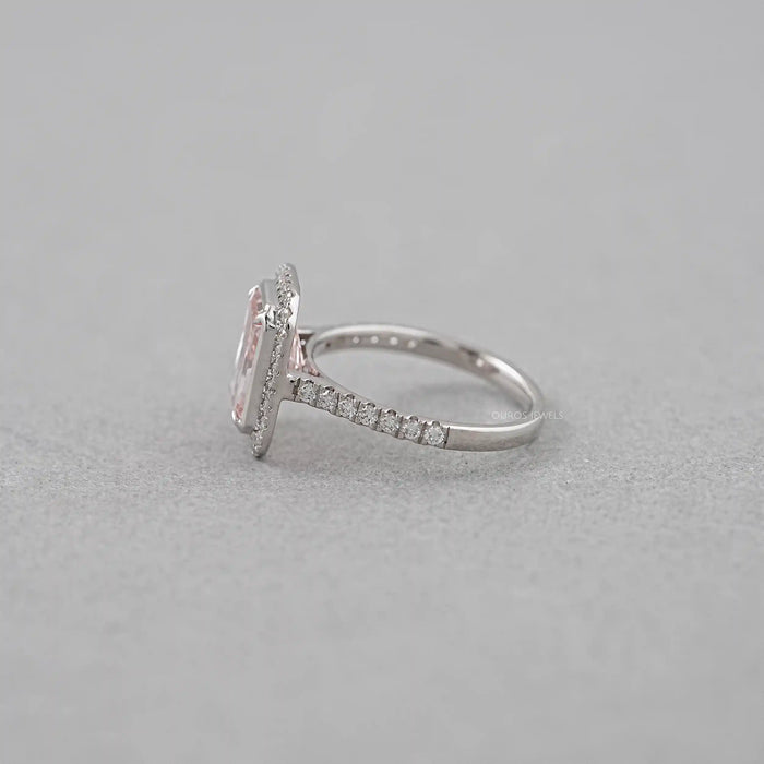side view of fancy pink radiant cut diamond halo engagement ring