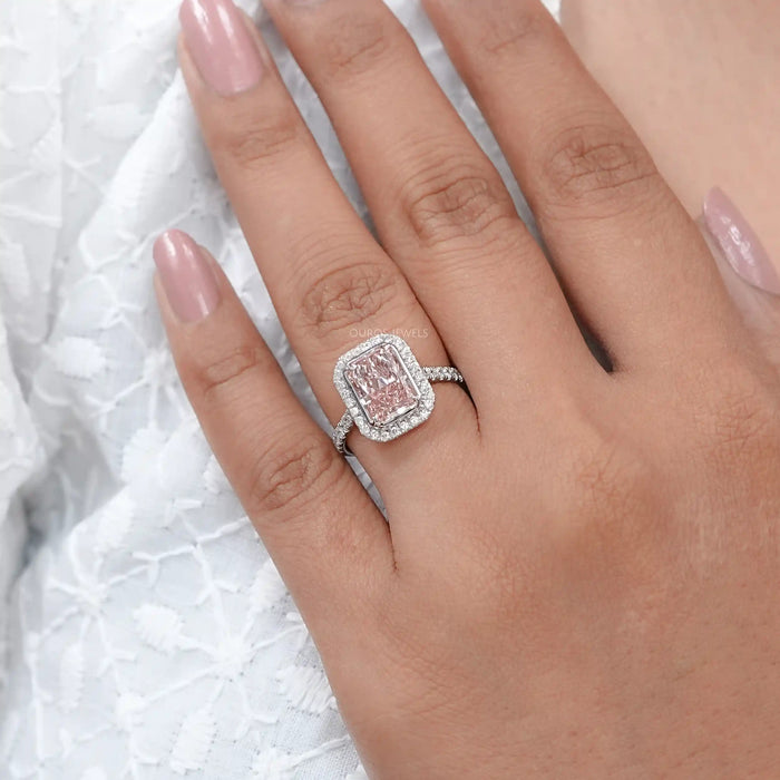 fancy pink radiant cut diamond halo engagement ring in finger