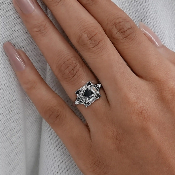 black round cut diamond baguette halo engagement ring on model's hand