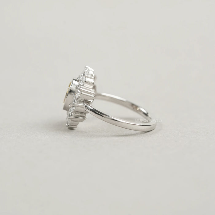 side view of yellow oval cut diamond bezel set with pear halo engagement ring