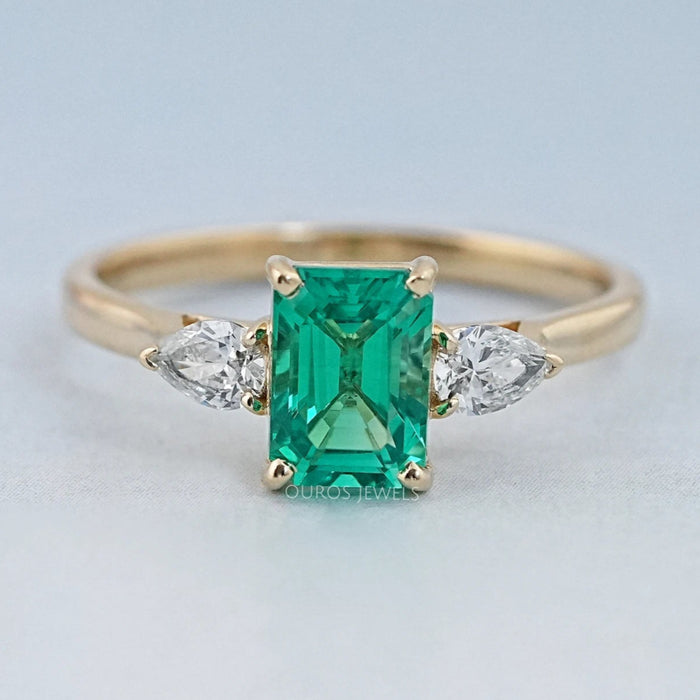 Emerald Gemstone And Pear Diamond Trio Engagement Ring