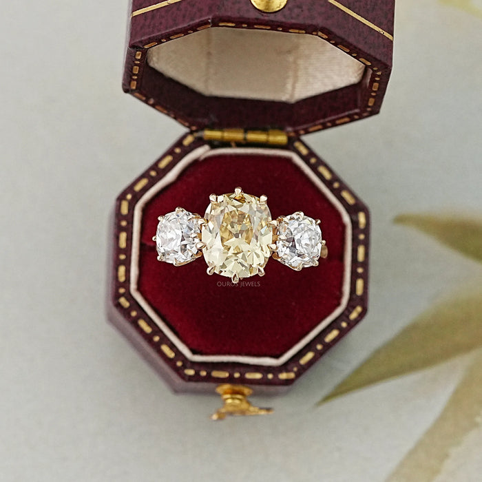 fancy yellow old mine cushion diamond three stone wedding ring in jewelry box