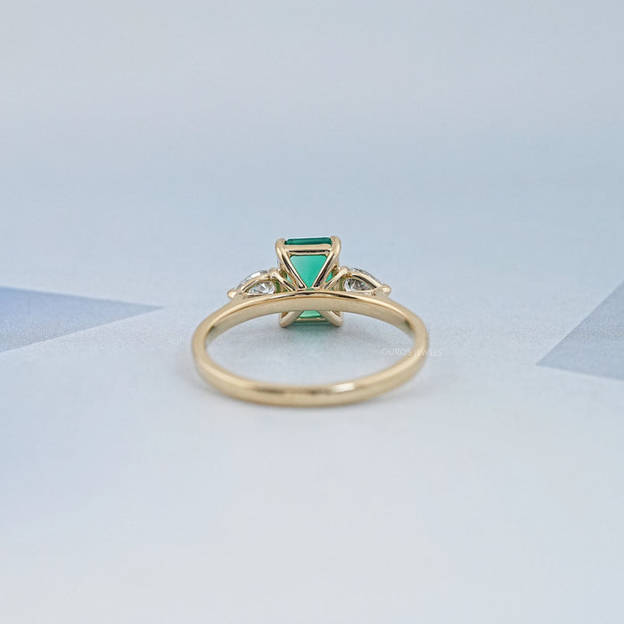 Emerald Gemstone And Pear Diamond Trio Engagement Ring
