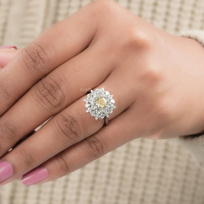 fancy yellow cushion lab diamond with heart & pear sunburst halo ring in finger
