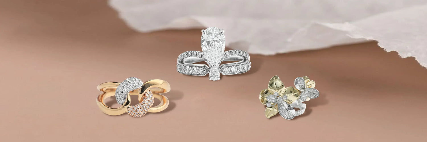 Three lab-grown diamond fashion rings — floral cluster bypass with fancy yellow diamonds, yellow gold interlocking loop with rose gold pavé, and pear cut solitaire with split pavé band