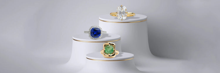 Image showing Cushion sapphire halo ring alongside a cushion solitaire engagement ring and a cushion emerald bezel-set ring