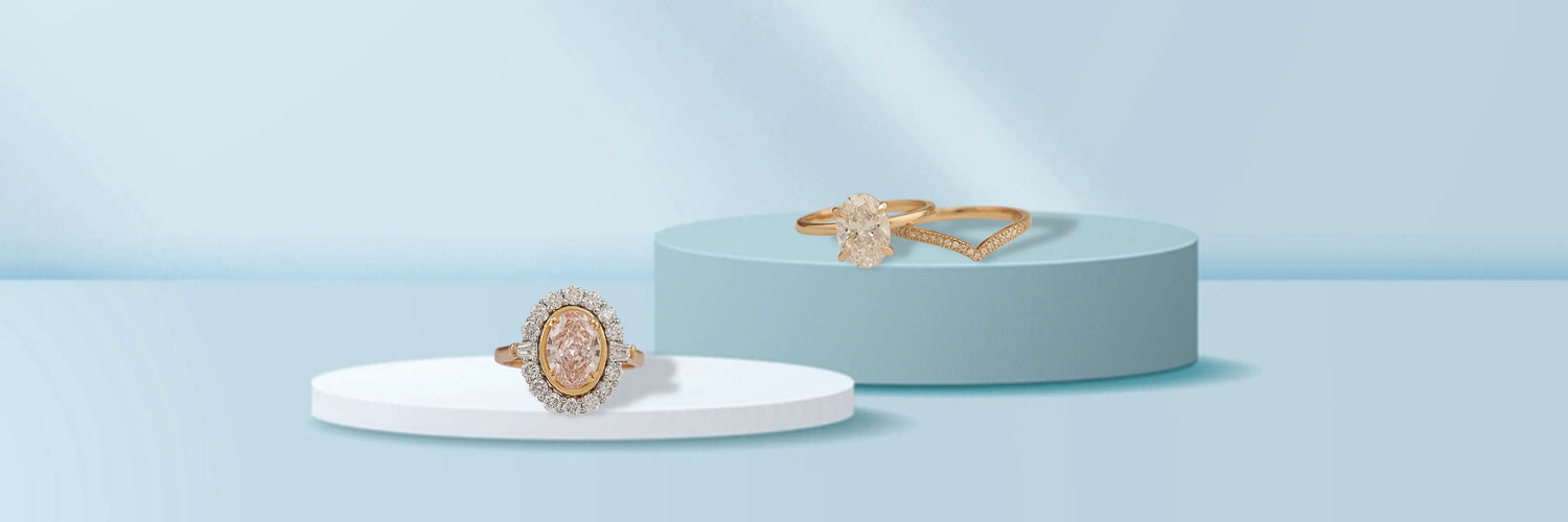 Three oval cut lab-grown diamond engagement rings in white gold — classic four-prong solitaire, oval diamond halo with pavé band, and east-west oval solitaire with full pavé band on black cylinder pedestals