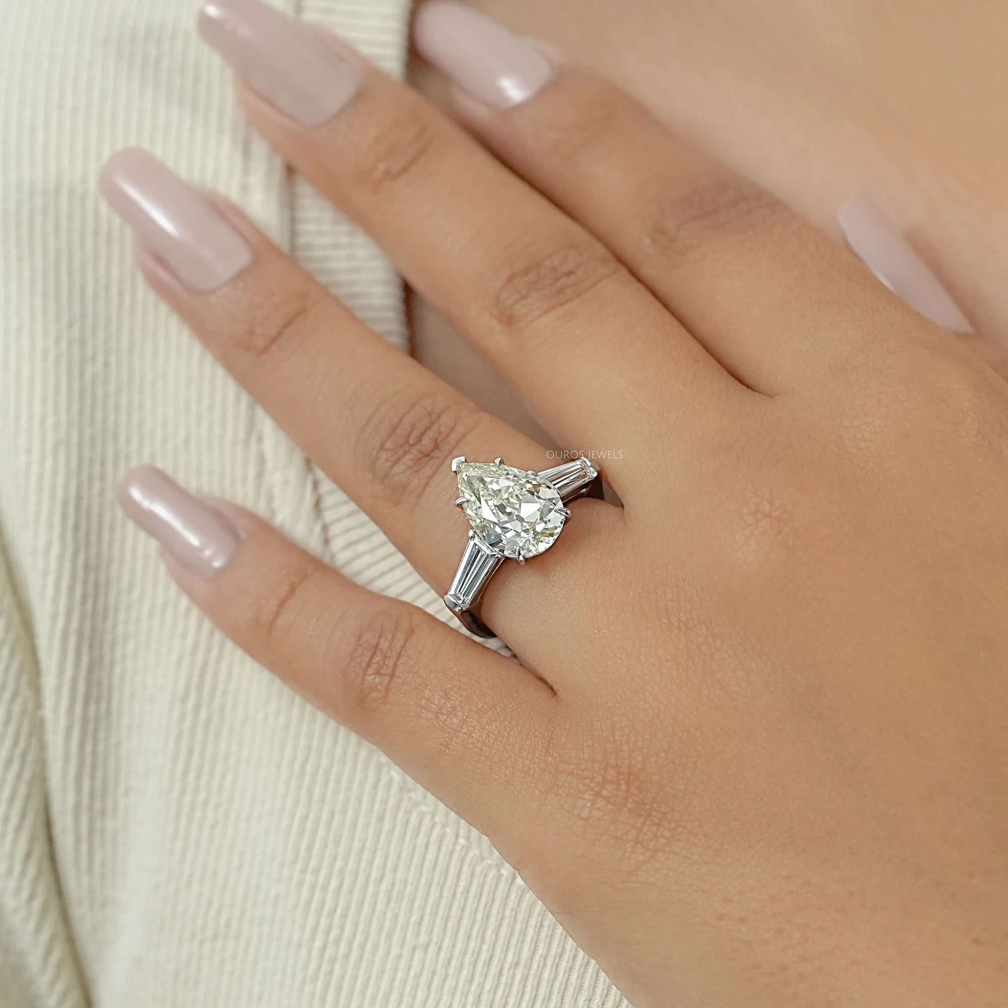 Pear Cut Three Stone Engagement Ring with Tapered Baguettes