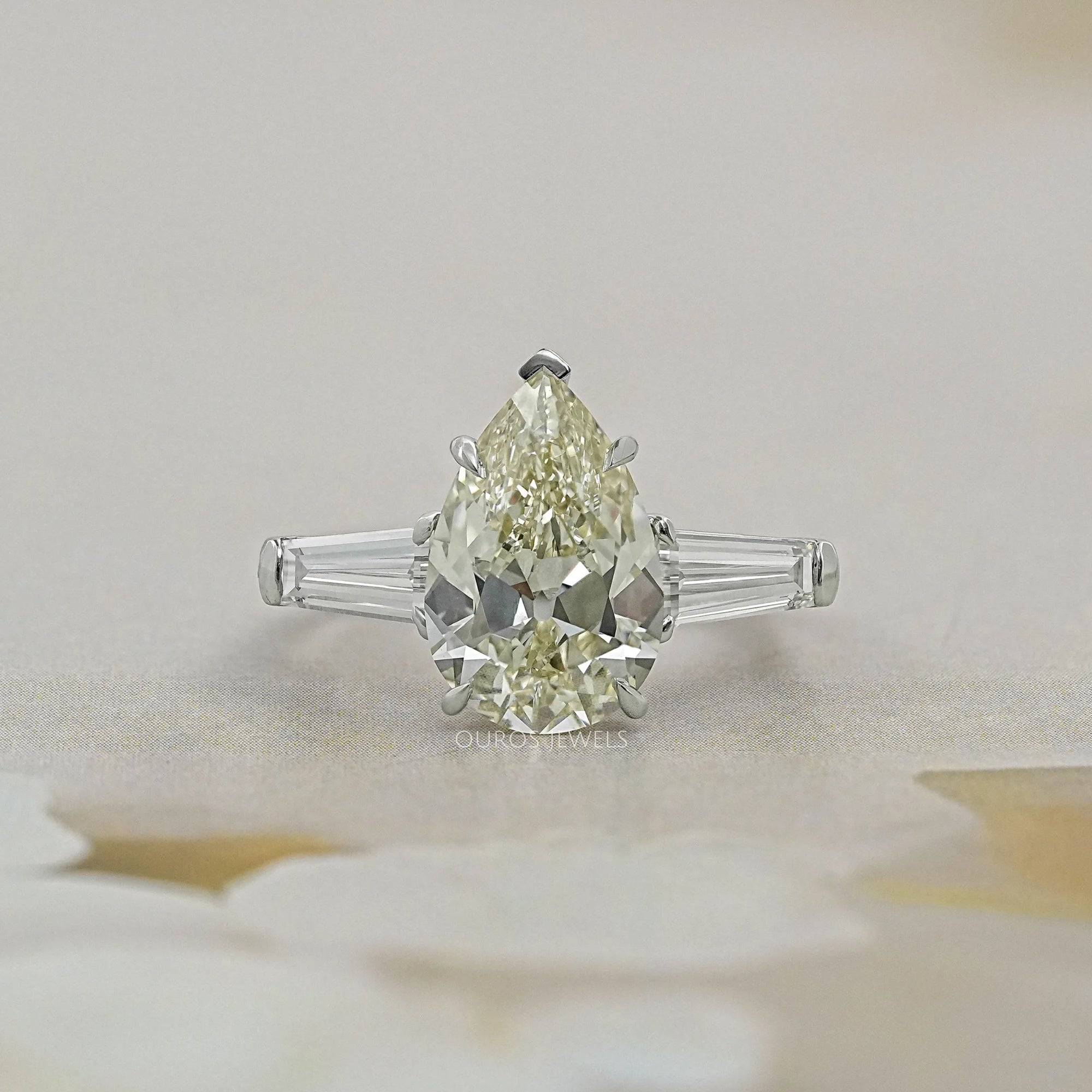 Pear Cut Three Stone Engagement Ring with Tapered Baguettes