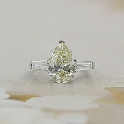 Pear Cut Three Stone Engagement Ring with Tapered Baguettes