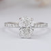 front view of oval-shaped diamond solitaire accent engagement ring on grey fabric