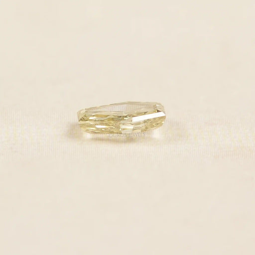 side view of calf head shape yellow loose lab created diamond