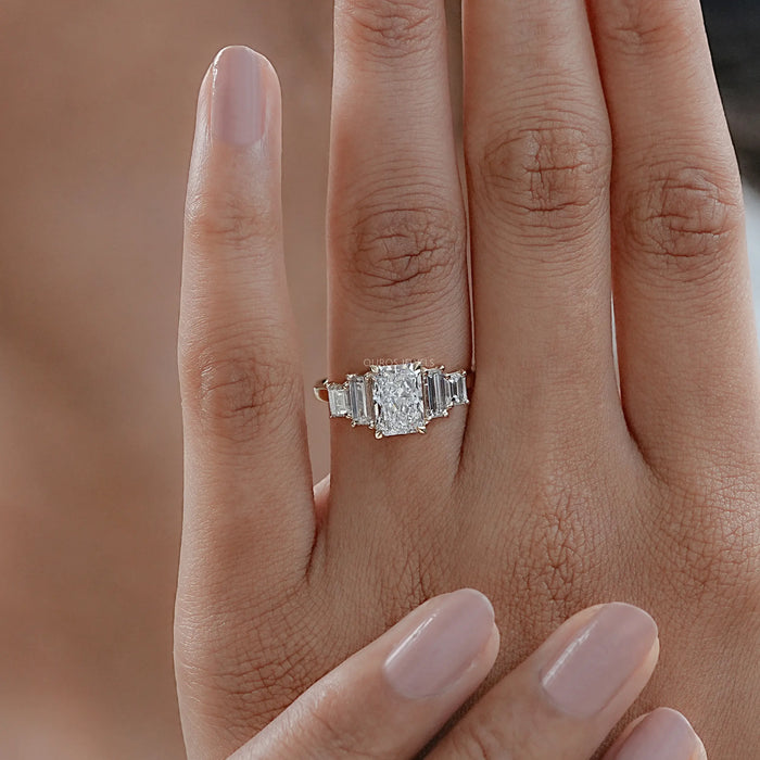 radiant and baguette cut lab diamond five stone engagement ring in finger