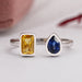 top view of yellow emerald and blue pear cut gemstone bezel set open cuff ring