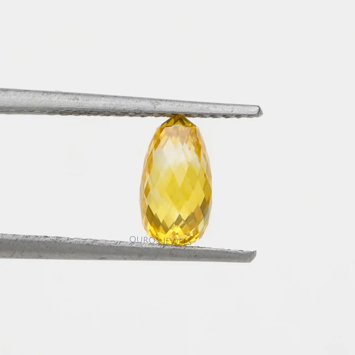 1.80 carat briolette cut diamond lab grown gemstone yellow held with tweezer