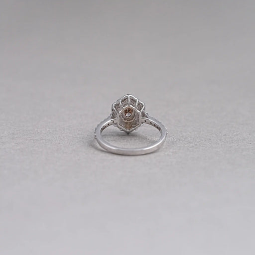 back view of oval cut brown diamond double halo engagement ring on grey fabric