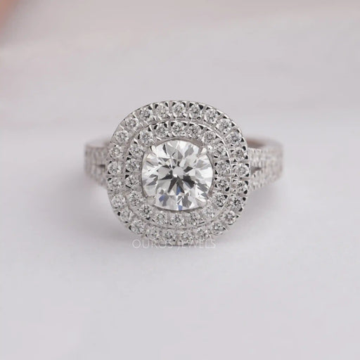 front view of round cut lab diamond double halo engagement ring on grey fabric