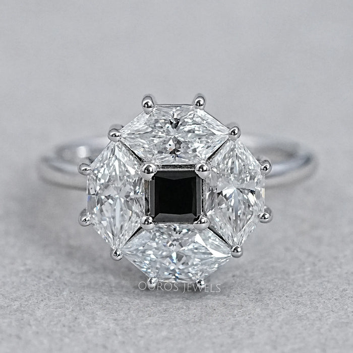 top view of princess cut lab diamond dutch marquise halo ring on grey fabric