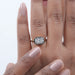 east west cushion diamond black coating solitaire engagement ring on model's hand