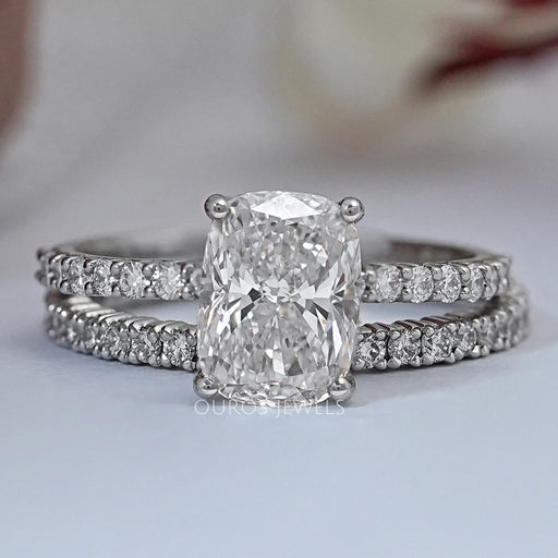 front view of elongated cushion-cut lab diamond bridal ring set on grey fabric
