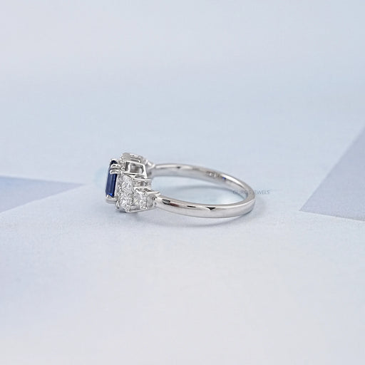 sapphire emerald diamond engagement ring with halo accent's side view