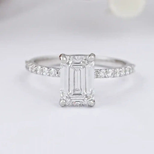 front view of igi certified emerald cut diamond solitaire accent ring on grey fabric