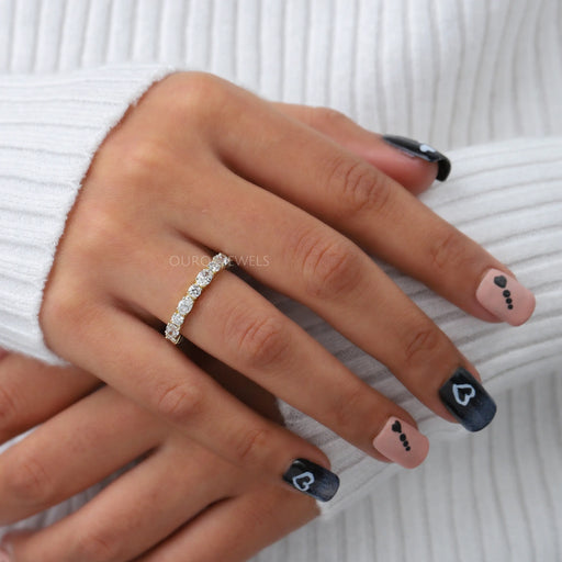 oval and round lab made diamond eternity ring yellow gold on finger