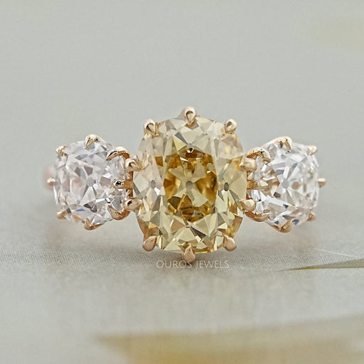 front view of fancy yellow old mine cushion diamond three stone wedding ring