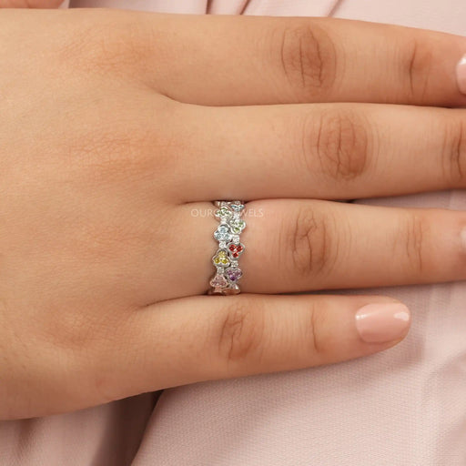 rainbow color round cut lab-grown diamond colored wedding band on model's finger