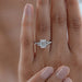 emerald cut and trapezoid lab diamond five stone engagement ring in finger